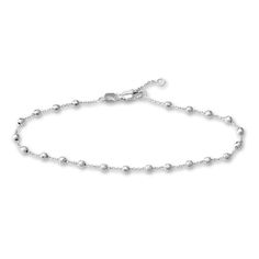 Distinctive diamond-cut beads brighten links around the length of this timeless women's station bracelet. Fashioned in 14K white gold, the 7.5-inch cable chain secures in place with a lobster clasp. Elegant Sterling Silver Ball Chain Bracelets, Elegant Sterling Silver Ball Chain Bracelet, Elegant Silver Bracelet With Satellite Chain, Elegant Silver Bracelet With Ball Chain, Elegant Silver Chain Bracelet With Satellite Chain, Modern Bracelets With Satellite Chain, Elegant Silver Ball Chain Bracelet, Modern Satellite Chain Bracelets, Silver Ball Chain Bracelet