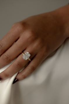 a woman's hand with a diamond ring on it