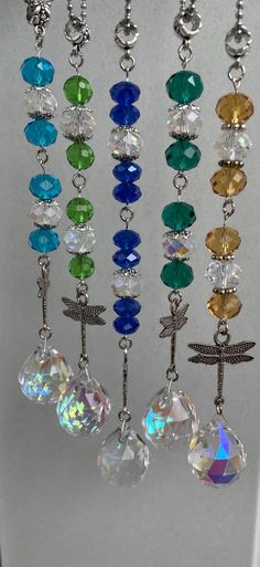 a bunch of different colored beads hanging from a hook