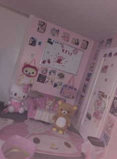 a pink room with teddy bears and pictures on the wall