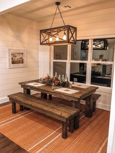 a wooden table and bench in a room