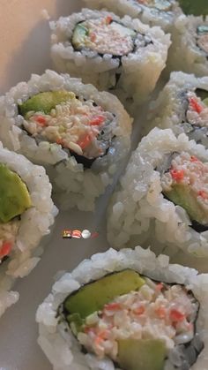 several sushi rolls are arranged on a white plate