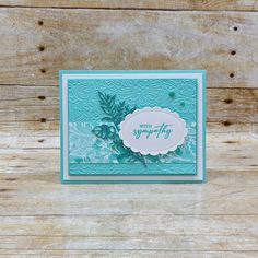 a close up of a greeting card on a wooden surface with wood planks behind it