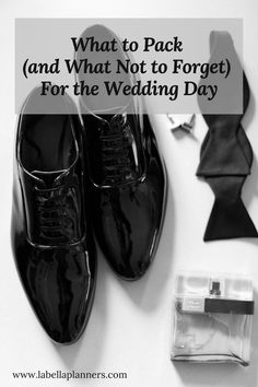 a pair of black shoes sitting on top of a white table next to a tie