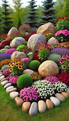 a garden filled with lots of different types of flowers and rocks in the middle of it