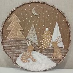 an ornament made to look like a christmas scene with deers and trees