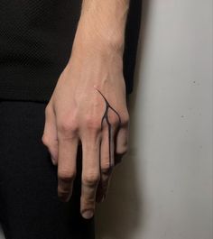 a person with a tattoo on their left hand