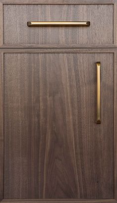 a wooden cabinet with brass handles and knobs on the front door is shown in this image