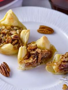 three pieces of pecan pie on a white plate