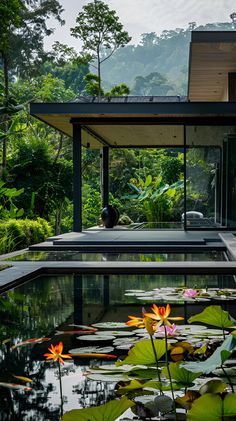 an outdoor pool surrounded by lily pads and greenery