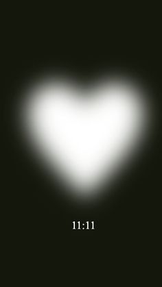 a white heart on a black background with the word 11 11 written in front of it