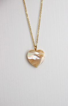 This delicate unique necklace was made of natural mother of pearl beige heart pendnat and high quality gold tone stainless steel chain with gold tone lobster claw. The chain is from lead & nickel free metal. Perfect jewelry for everyday wear and a great gift for someone special! The length of necklace is 45 cm or 17.7 inches. Other necklaces of my shop you can see here: https://www.etsy.com/shop/NaTavelli?section_id=14843046&ref=shopsection_leftnav_5 Thanks for a visit. White Shell Necklace With Pearl Pendant As Gift, Mother Of Pearl Pendant Jewelry Gift, Mother Of Pearl Pendant Jewelry For Gifts, Bohemian Pearl Charm Necklace Gift, Bohemian Pearl Charm Necklace As Gift, Pearl White Mother Of Pearl Shell Necklace As Gift, Pearl White Mother Of Pearl Shell Necklace Gift, Spiritual Round Mother Of Pearl Jewelry, Delicate White Mother Of Pearl Necklace