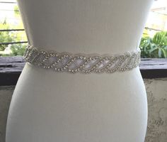 A beautiful classy and classic crystal and Rhinestone sash with best quality rhinestones and silver beading is attached to a satin ribbon .    Beading measures 20x1. This sash ties in the back with an elegant satin ribbon .    The satin ribbon sash showing in the picture is white ribbon with 1 inch wide    Satin ribbon is available in different width and color.    ***Matching headband,garter and bracelet is also available please contact me.    ***Were proud to offer FREE GARTER on every Sash ... Wedding Belt, Wedding Sash Belt, Wedding Sash, Bridal Sash, Wedding Belts, Bridal Belt, Rhinestone Bridal, Matching Headband, White Ribbon