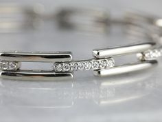 This white gold and diamond link bracelet is quite lovely, crafted in 14K white gold, giving it a luxurious feeling on the wrist. Bright diamonds are pave set in every other link, giving the bracelet an elegant profile. This piece closes securely, with an added locking clasp for safety. Metal: 14K White Gold Gem: 72 Diamonds totaling 1.62 Carats, H in Color, SI3 in Clarity Gem Measurements: 1.3 mm, Round Width: 5.8 mm Length: 7 1/2 Inches Marks: "14K" Stamped on the clasp Bracelet Layering, Bracelet Stacking, Cameo Ring, Layered Bracelets, July Birthstone, Bracelet Stack, Eternity Bands, Chain Link Bracelet, White Gold Diamonds