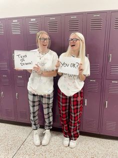 two women standing in front of lockers holding signs that say, you ok?