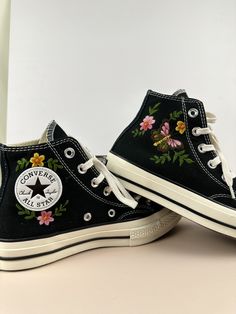 two black shoes with flowers painted on them