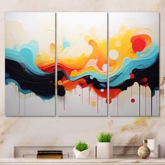 three abstract paintings on a wall in a living room