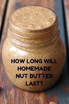 a jar filled with peanut butter sitting on top of a wooden table