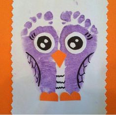 an orange and white paper with a purple owl drawn on it's face in the shape of a handprint