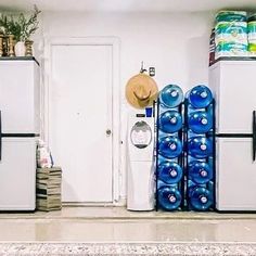 three refrigerators are stacked on top of each other in a kitchen with blue and white decorations