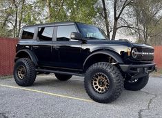 a large black truck parked in a parking lot