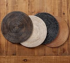 three woven baskets on top of a wooden table