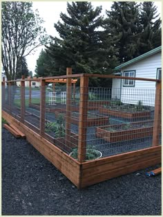 a fenced in garden area next to a house