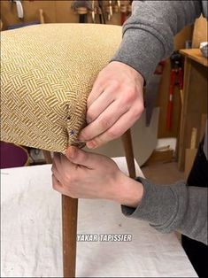 a person is working on a chair cushion