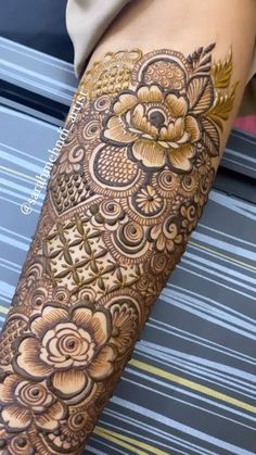 a woman's arm with an intricate tattoo on it