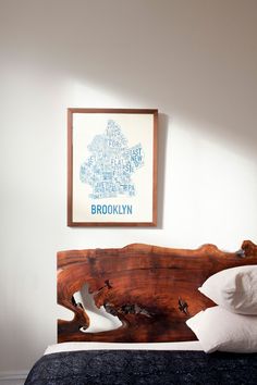 a bed with a wooden headboard and foot board on top of it in a bedroom