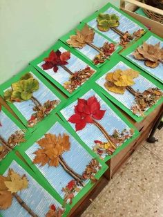 the table is set up with many different leaves on it and there are also place mats for each leaf