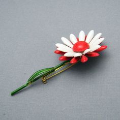 Vintage flower brooch on stem is a wonderful pop of color with a green stem and red and white flower. In excellent vintage condition, signed Original by Robert, 3 1/2 inches tall with the flower being about 1 5/8 inch in diameter. Find lots more vintage jewelry at Purple Daisy Jewelry! http://www.etsy.com/shop/purpledaisyjewelry Thanks a bunch for shopping for vintage jewelry at Purple Daisy Jewelry on Etsy! Vintage Flower Lapel Pin Gift, Vintage Flower Lapel Pin For Gift, Vintage Red Lapel Pin As Gift, Vintage Red Lapel Pin For Gift, Red Vintage Lapel Pin As Gift, Red Vintage Lapel Pin For Gift, Vintage Red Pins For Gifts, Vintage Red Pins For Gift, Vintage Red Pins As Gift