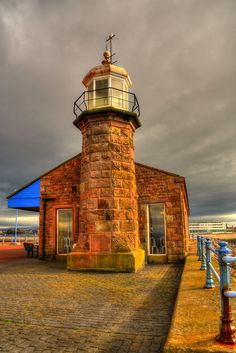 an old brick building with a light tower on top