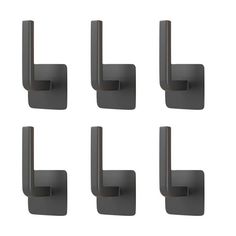 six black wall mounted hooks on the side of a white wall with four different sized handles