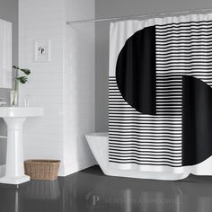 a bathroom with a black and white shower curtain next to a bathtub in the corner