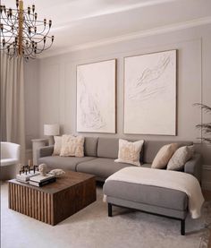 a living room filled with furniture and a chandelier