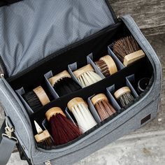 an open suitcase filled with different types of brushes