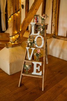 a ladder decorated with flowers and the word love