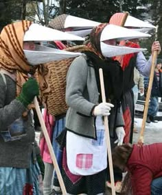 some people are standing in the snow with skis on their heads and holding poles