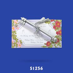 the wedding stationery is decorated with flowers and ribbons