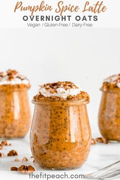 three glass jars filled with pudding and topped with whipped cream, walnuts and pecans