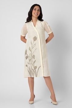 Off-white dress with dainty bloom print, zari embroidered hem and ruffle V neckline. - Aza Fashions Fitted White Dresses With Embroidered Sleeves, Fitted White Dress With Embroidered Sleeves, White Knee-length Embroidered Fitted Dress, White Knee-length Fitted Embroidered Dress, White Fitted Knee-length Embroidered Dress, Fitted Cotton Embroidered Knee-length Dress, Fitted Knee-length Cotton Embroidered Dress, Elegant White Dress With Embroidered Hem, Elegant Cotton Embroidered Midi Dress