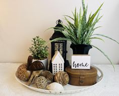 a white plate topped with potted plants and decorative items