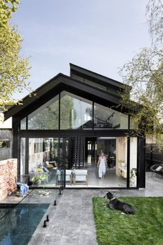 a house with a pool in the yard and grass on the ground next to it