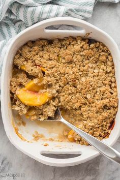 a casserole dish with peaches and oatmeal crumbles