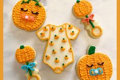 decorated cookies are arranged in the shape of pumpkins and ones with faces on them