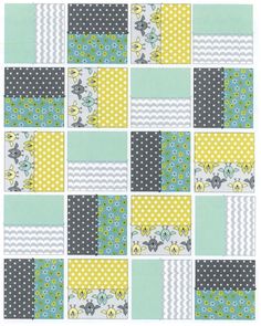 a patchwork quilt with yellow, blue and green squares on it's sides