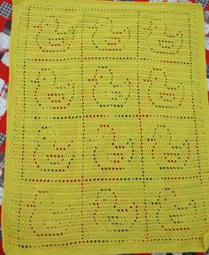 a yellow crocheted blanket with words written on it