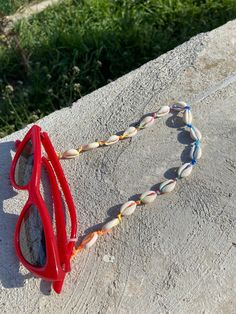 Rainbow cord with natural cowrie shell sunglasses chain, light and easy to wear. Length is 70 cm This sunglasses chain will add a summerish touch to your sunglasses or eyeglasses! Cowrie shells are natural so their size is not identical! Thanks for stopping by and don't forget to check my other listings too! Have a great day  Veronica Adjustable Chain Beach Jewelry, Multicolor Glasses Chains For Summer Beach, Handmade White Glasses Chains For Festival, Handmade White Glasses Chains For Summer, White Adjustable Glasses Chains For Summer, Trendy White Glasses Chains For Festival, Summer Festival Glasses Chains With Adjustable Chain, Trendy Shell Jewelry For Beach, Trendy Shell Jewelry For The Beach