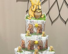 a three tiered cake with winnie the pooh on it